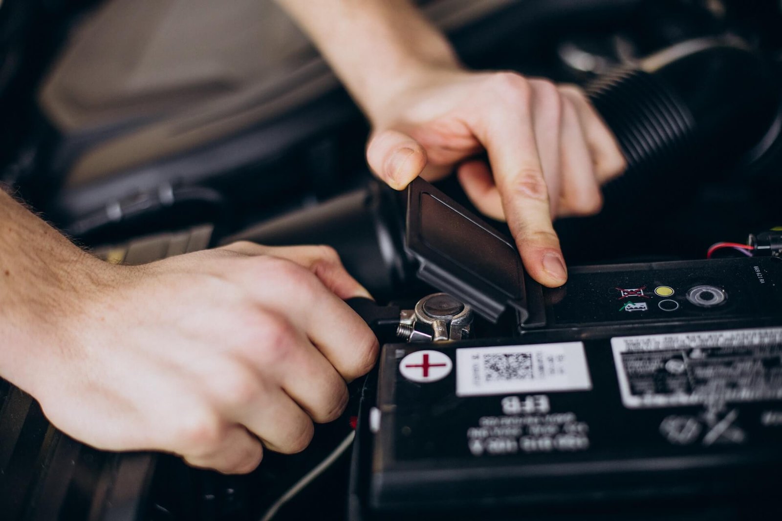 Technician fitting a replacement 12V battery