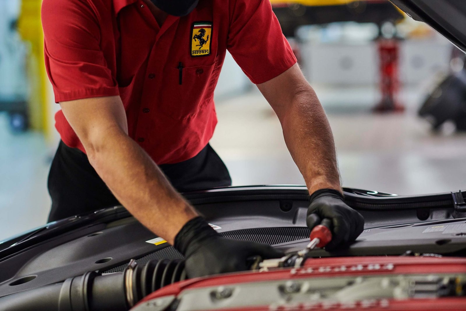 Technician testing a Ferrari air conditioning system