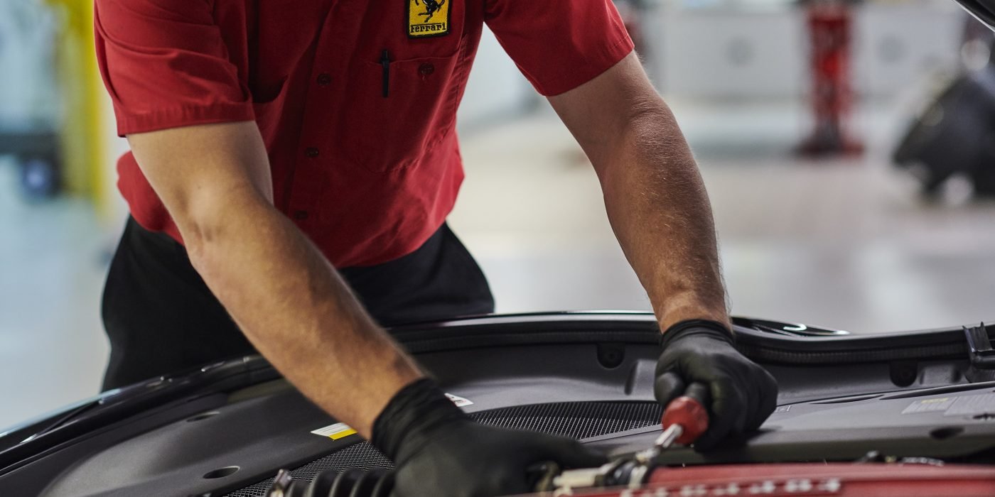 Ferrari technician inspecting a vehicle in a workshop in Dubai