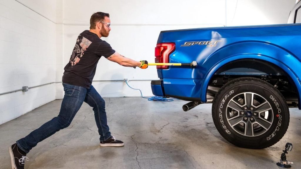Ford panel dent inspected for paintless repair in Dubai