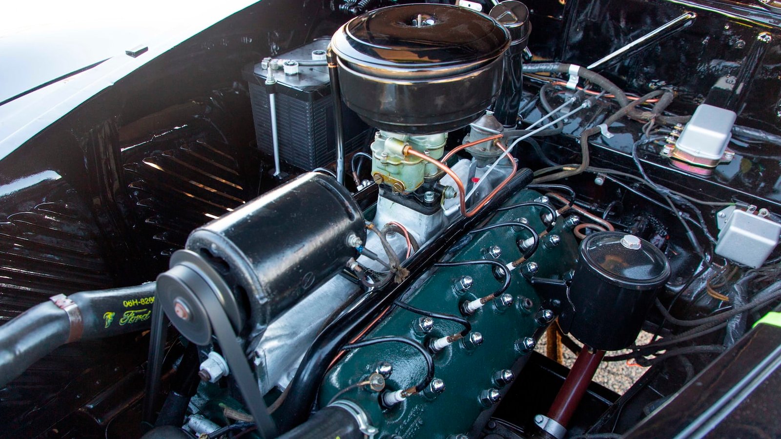 Technician comparing old and new Lincoln suspension components