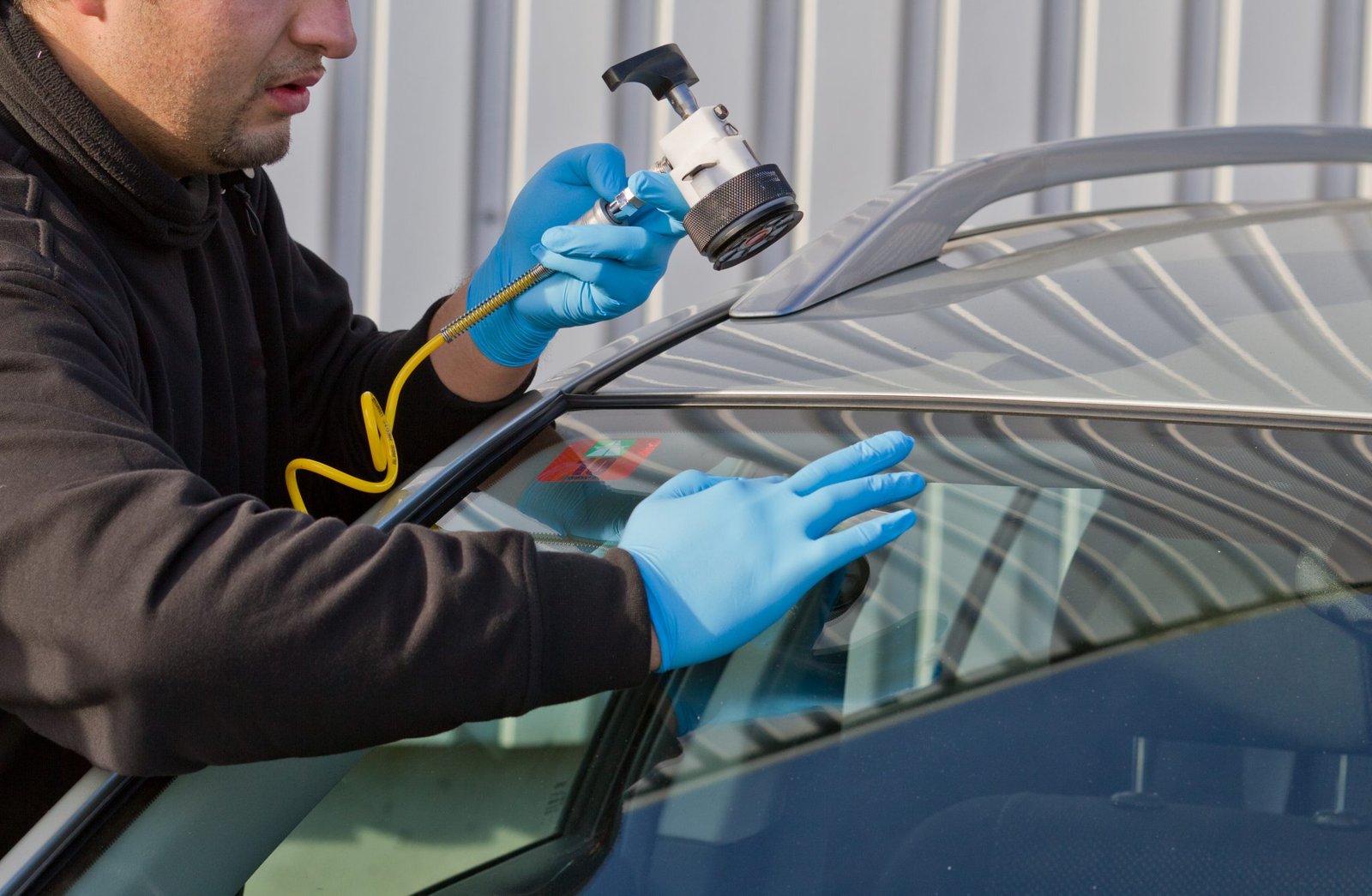Lincoln SUV receiving windscreen replacement in a Dubai workshop