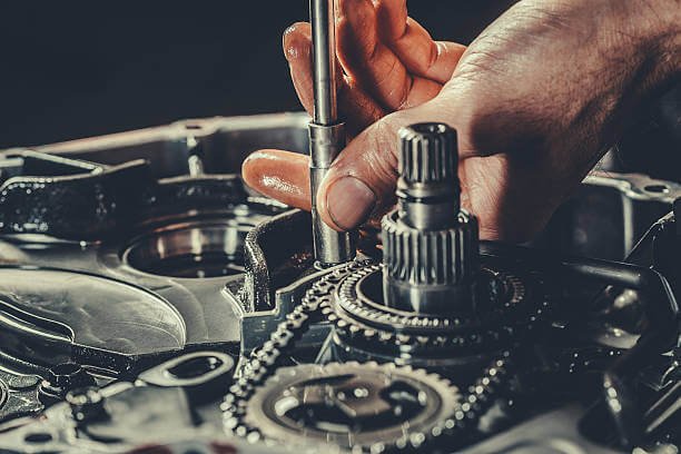 Technician working on BMW transmission components