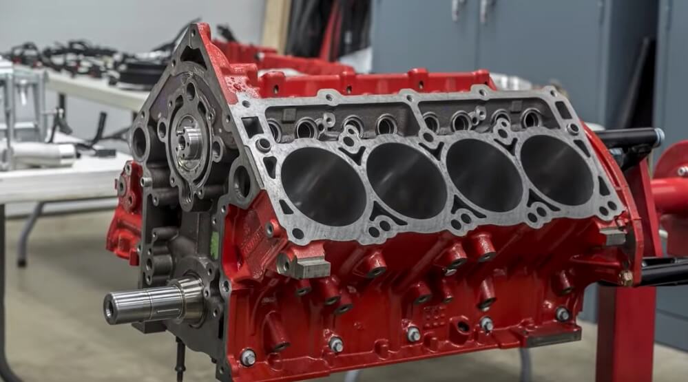 Red Dodge engine block prepared for measurement and repair