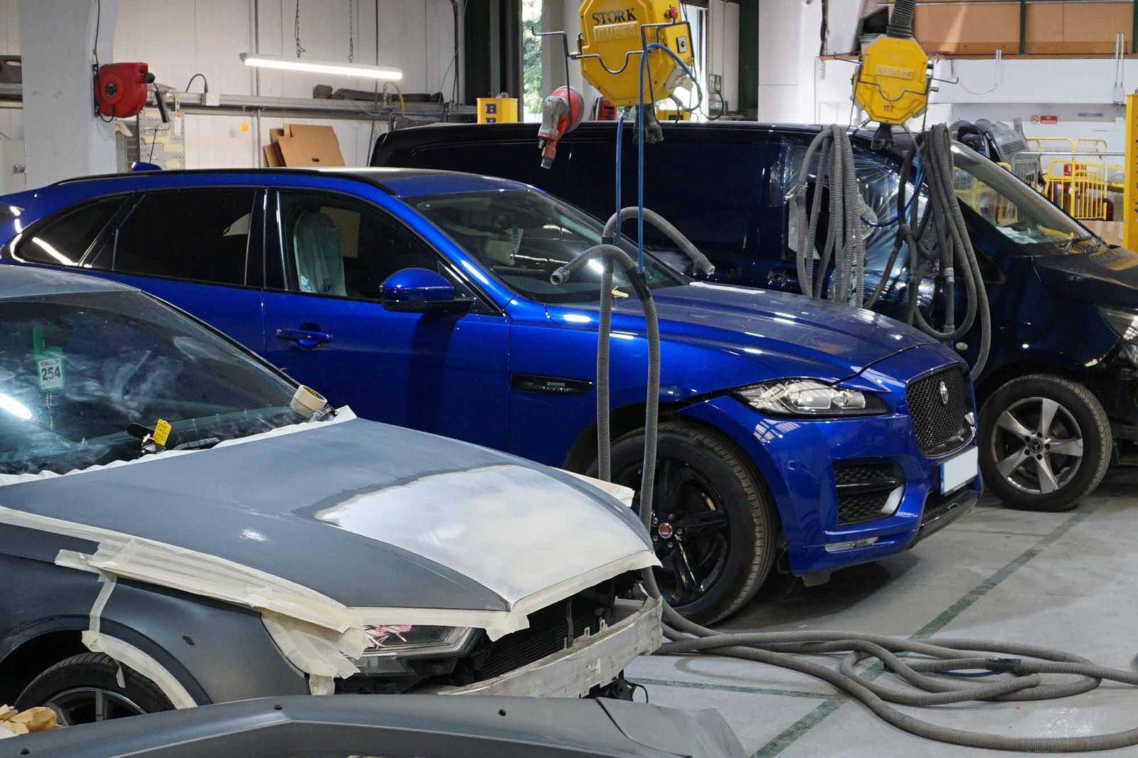 Jaguar body panel being assessed for dent repair