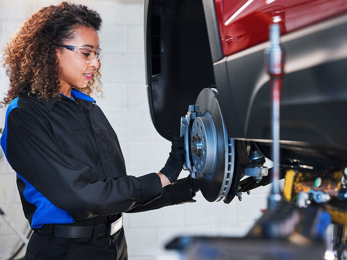 Technician checking a Volkswagen brake disc and caliper