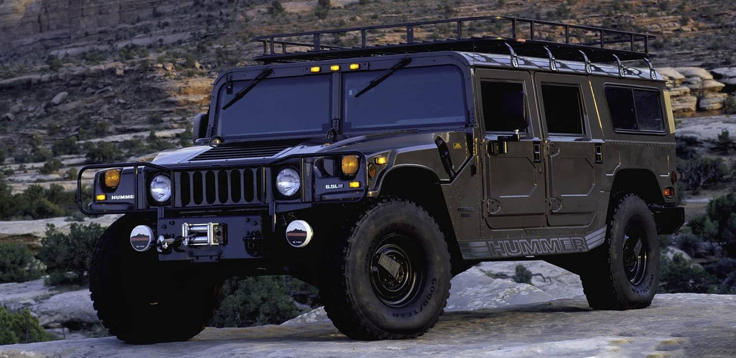 Dark Hummer H1 parked outdoors