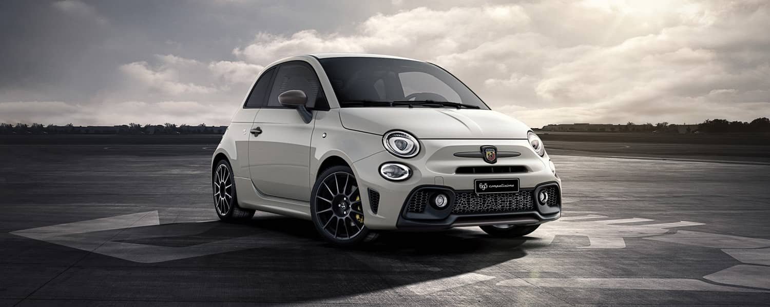 White Abarth hatchback parked outdoors