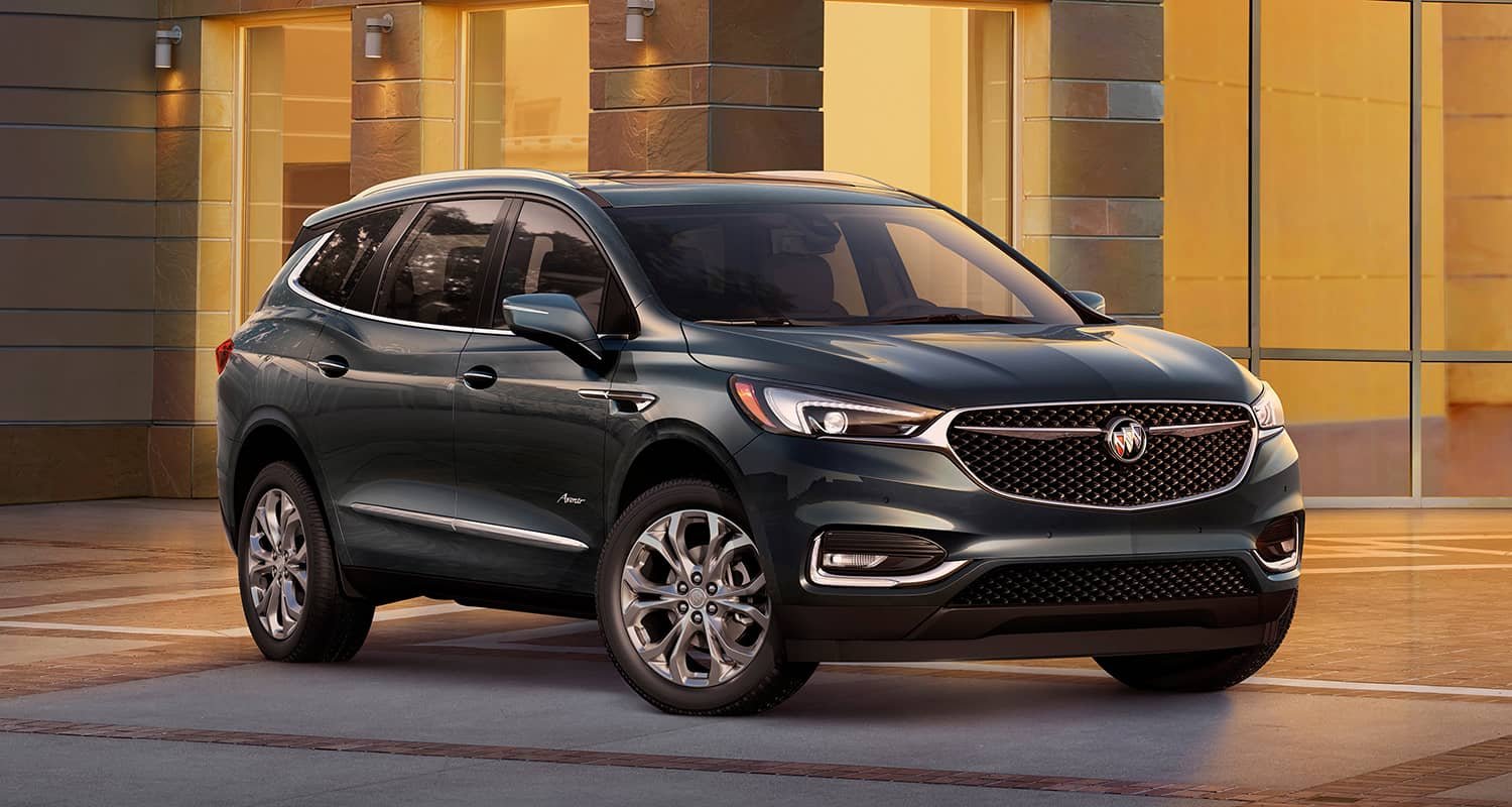 Dark Buick SUV parked outside a building