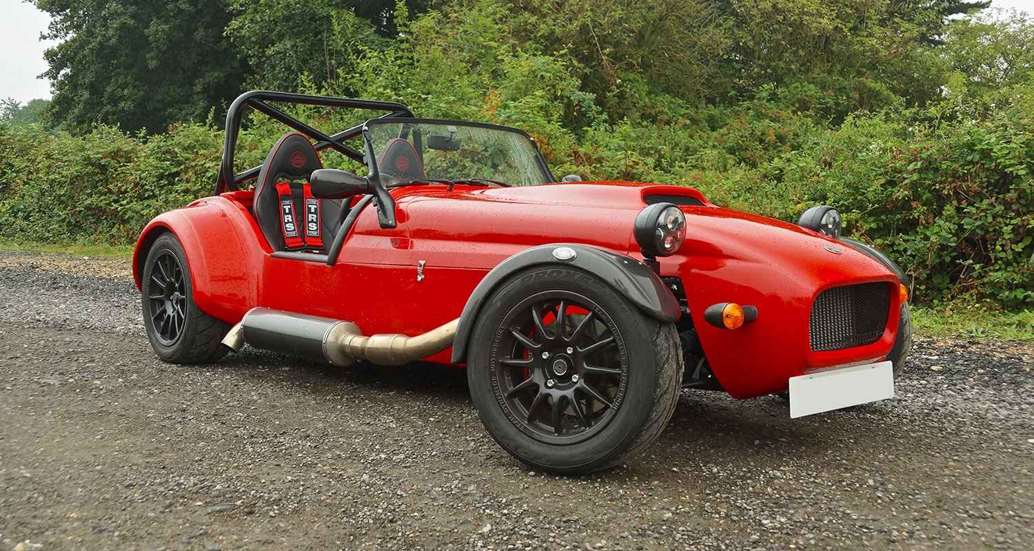 Red Westfield sports car parked outdoors