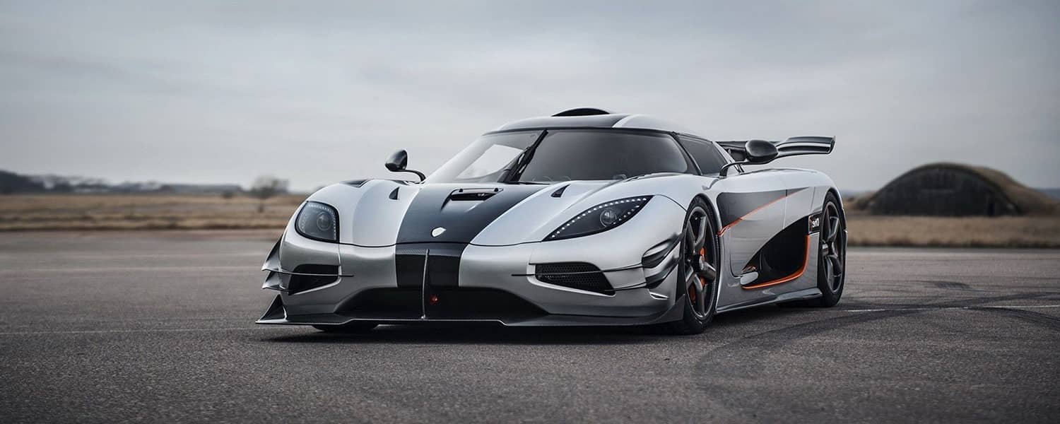 White Koenigsegg parked outdoors