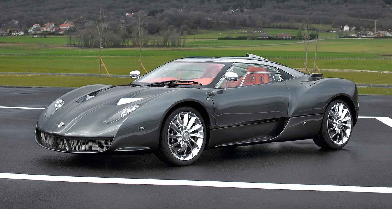 Grey Spyker sports car with red interior photographed outdoors
