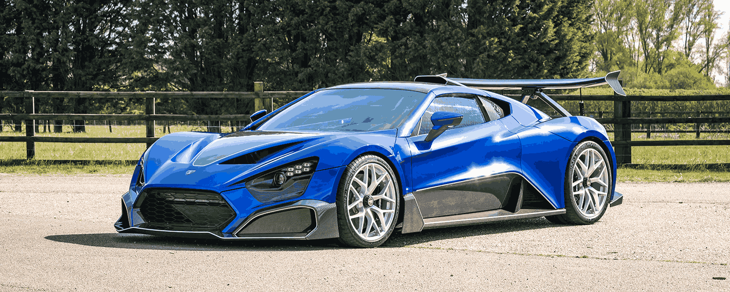 Blue Zenvo hypercar outdoors, shown from the front and side