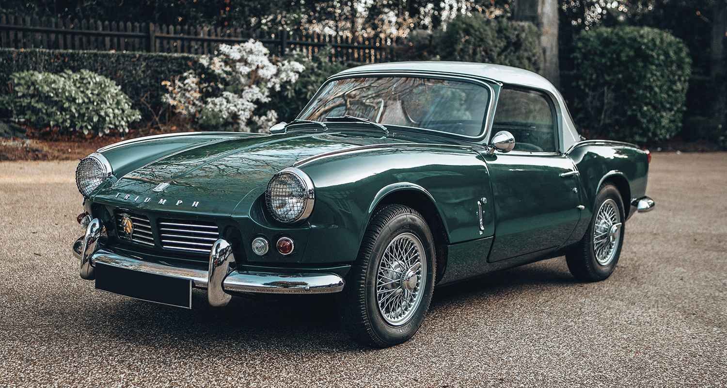 Green classic Triumph roadster parked outdoors