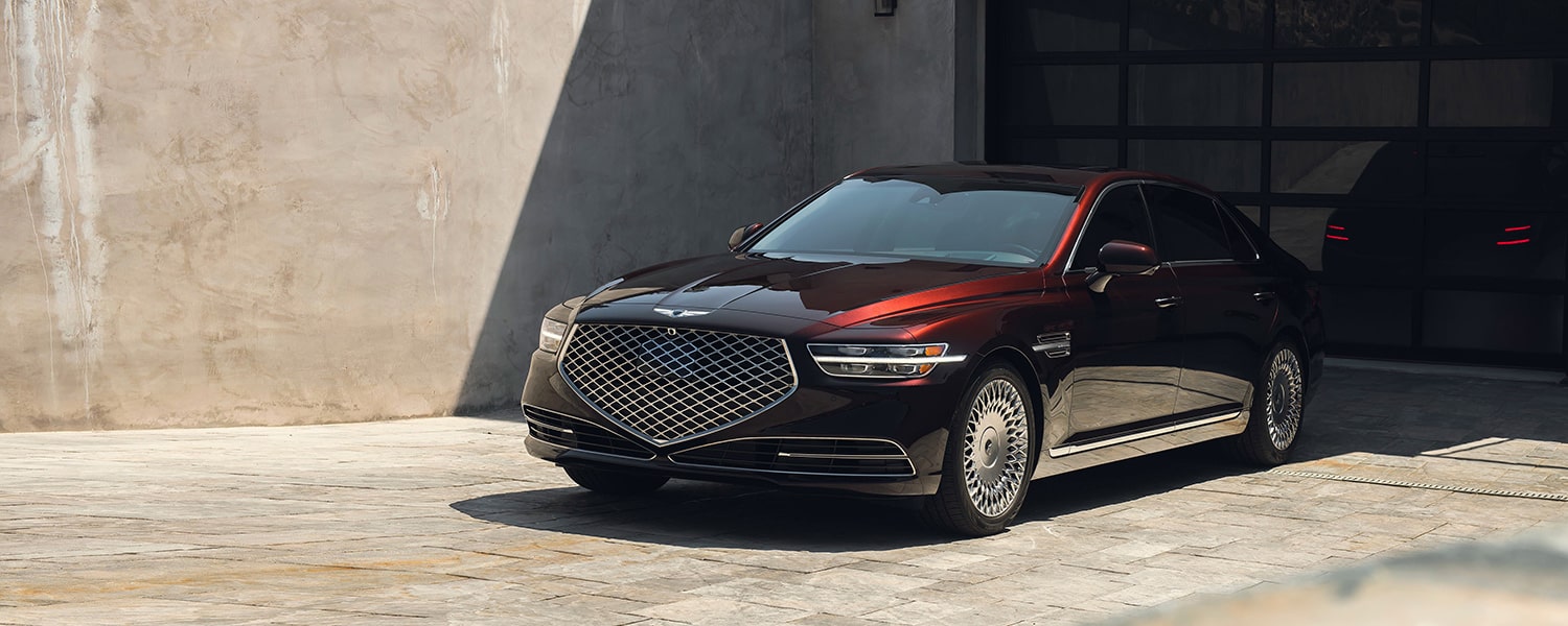 Dark red Genesis sedan prepared for an independent workshop assessment in Dubai