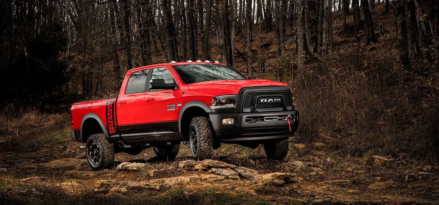 Red RAM pickup on a rocky forest trail