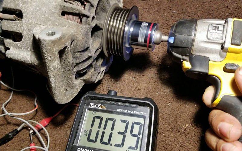 Technician testing an alternator during electrical diagnosis