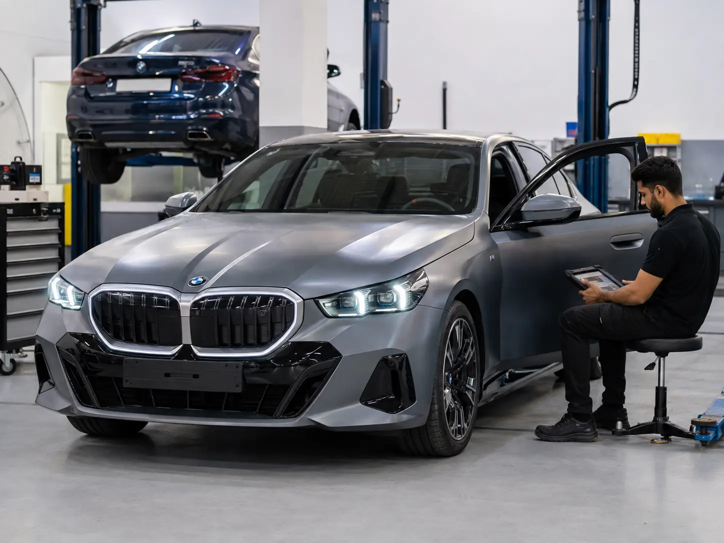 Technician completing a final diagnostic verification on a current BMW i5