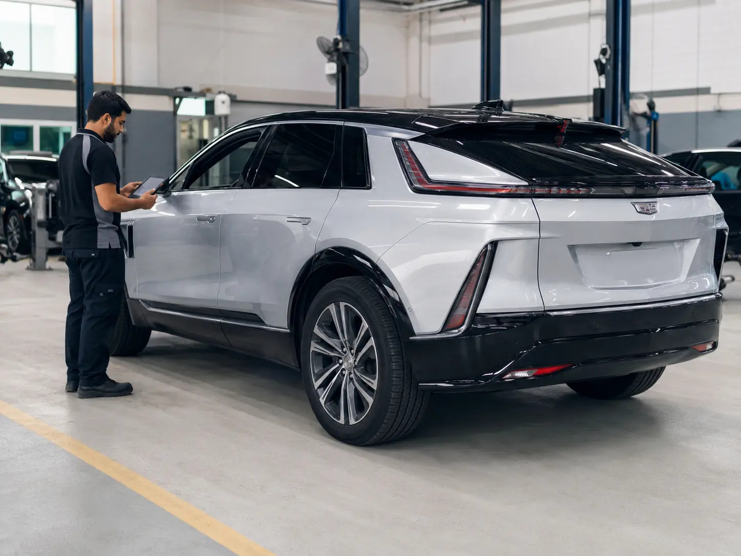 Technician completing a low-voltage and systems verification on a current Cadillac LYRIQ