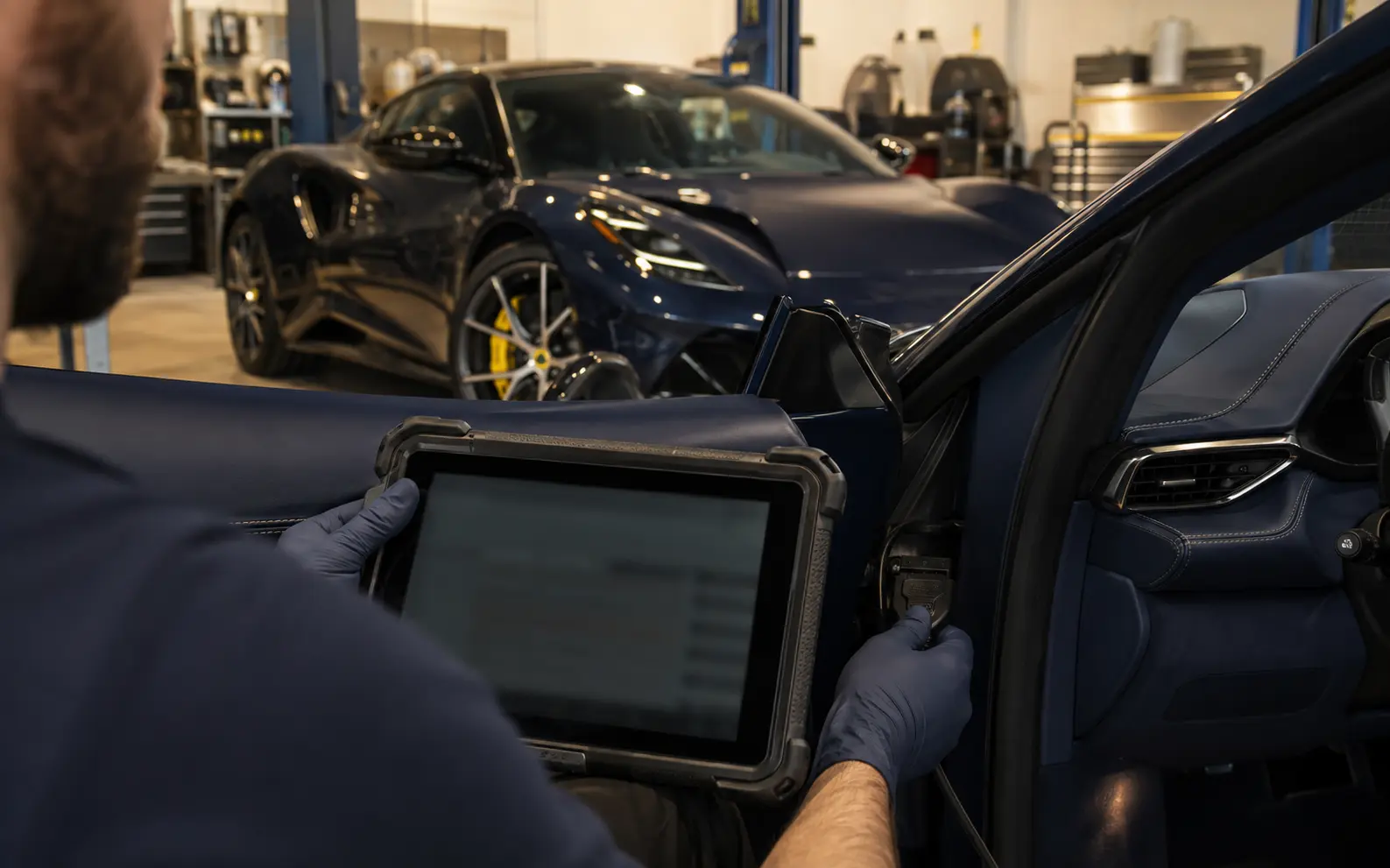 Technician connecting diagnostic equipment to a current Lotus Emira