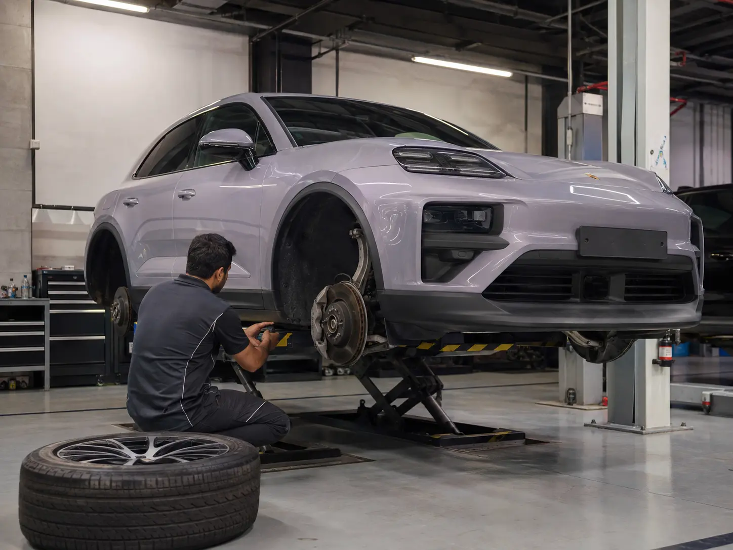 Porsche Macan brake and suspension inspection on a workshop lift