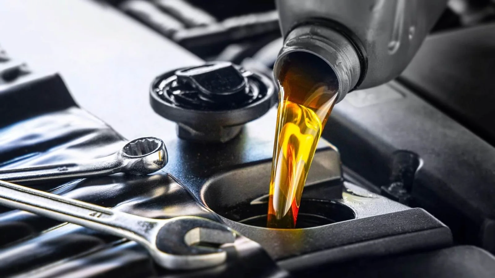 Engine oil being poured into a vehicle during an oil change