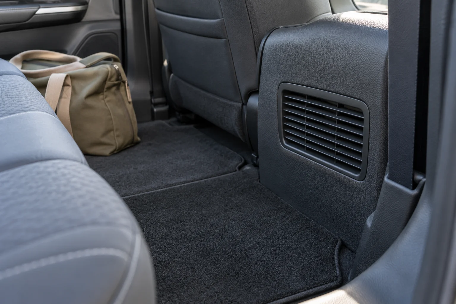 Unobstructed battery cooling intake grille beside a rear seat